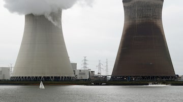 A boat sails next to the cooling towers of the Doel nuclear plant of Electrabel, the Belgian unit of French company Engie, former GDF Suez, in Doel near Antwerp, Belgium October 7, 2020. REUTERS/Francois Lenoir