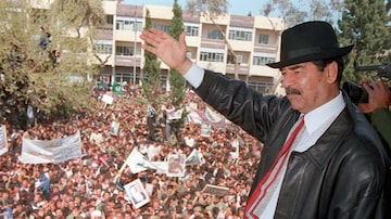 FP130 This photo released by the Iraqi News Agency 02 April shows Iraqi President Saddam Hussein waving to supporters during his visit to the town of Kirkuk north of Baghdad.  UN weapons experts, accompanied by diplomats, have entered all eight presidential sites and should complete their initial inspections within the next few days, said a UN official 02 April.   AFP PHOTO INA