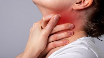 Asthma attack. Woman suffocating, breathing heavily. Sore throat. Hands holding neck with red spot closeup. Respiratory diseases, medicine concept. High quality photo. Foto: valiantsin/Adobe Stock        
