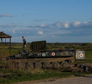 Local boy Faddei stands atop a destroyed Russian armoured military vehicle in the village of Kolychivka, in Chernihiv region, Ukraine April 27, 2022.  REUTERS/Vladyslav Musiienko