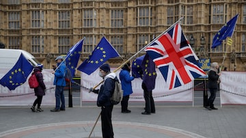 Manifestantes a favor (1º plano) e contra o Brexit (2º plano) se manifestam no entorno do Parlamento britânico. Foto: AP Photo/Matt Dunham