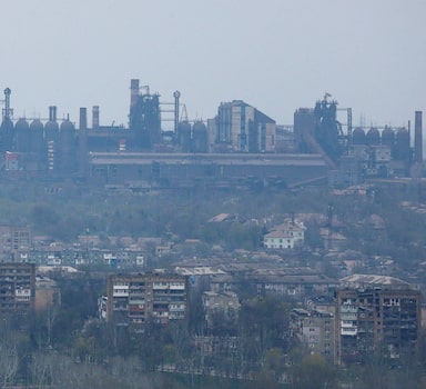A view shows a plant of Azovstal Iron and Steel Works company behind buildings damaged in the course of Ukraine-Russia conflict in the southern port city of Mariupol, Ukraine April 19, 2022. REUTERS/Alexander Ermochenko