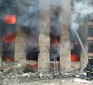 In this handout screen grab taken from a footage of the State Emergency Service of Ukraine released on March 13, 2022, firemen work on the aftermath of air strikes on residential buildings in Chernihiv early on March 13, 2022. (Photo by Handout / State Emergency Service of Ukraine / AFP) / RESTRICTED TO EDITORIAL USE - MANDATORY CREDIT "AFP PHOTO / STATE EMERGENCY SERVICE OF UKRAINE " - NO MARKETING - NO ADVERTISING CAMPAIGNS - DISTRIBUTED AS A SERVICE TO CLIENTS
