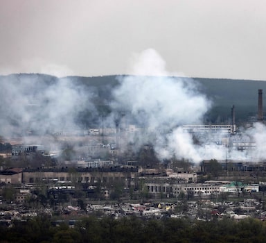 A photograph taken from Novodruzhesk village, shows smoke rising in Rubizhne city, on April 18, 2022, on the 54th day of the Russian invasion of Ukraine. - A series of "powerful" Russian strikes on military infrastructure in Lviv on April 18, 2022, left several dead and ignited blazes in the west Ukraine city that has been spared fierce fighting. (Photo by RONALDO SCHEMIDT / AFP)