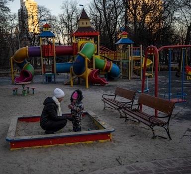 Olga plays with her daughter Vedeneya in an empty park in Kyiv, Ukraine, Friday, March 18, 2022. (AP Photo/Rodrigo Abd)