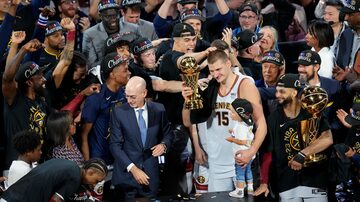 Denver Nuggets center Nikola Jokic, center, holds up the MVP award after the team won the NBA Championship with a victory over the Miami Heat in Game 5 of basketball's NBA Finals, Monday, June 12, 2023, in Denver. (AP Photo/David Zalubowski)