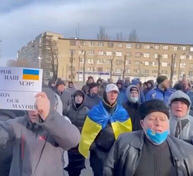 People protest the abduction of Mayor Ivan Fedorov, outside the Melitopol regional administration building, after he was reportedly taken away by Russian forces, during their ongoing invasion, in Melitopol, Ukraine in this still image obtained from handout video released March 12, 2022. Courtesy of Deputy Head for President's Office, Ukraine/Handout via REUTERS THIS IMAGE HAS BEEN SUPPLIED BY A THIRD PARTY. REUTERS HAS VERIFIED THE VIDEO'S LOCATION. MANDATORY CREDIT. NO RESALES. NO ARCHIVES
