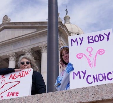 FILE - Dani Thayer, left, and Marina Lanae, right, both of Tulsa, Okla., hold pro-choice signs at the state Capitol, Wednesday, April 13, 2022, in Oklahoma City. Oklahoma's Republican-led state Legislature passed several anti-abortion restrictions in recent weeks, part of a movement in conservative states to curtail women's reproductive rights. Anti-abortion lawmakers are hopeful the conservative-leaning U.S. Supreme Court might even overturn the nationwide right that has existed for nearly 50 years. (AP Photo/Sue Ogrocki File)