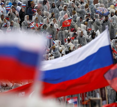 Russian flags are seen as people attend the Immortal Regiment march on Victory Day, which marks the 77th anniversary of the victory over Nazi Germany in World War Two, in central Moscow, Russia May 9, 2022. REUTERS/Maxim Shemetov