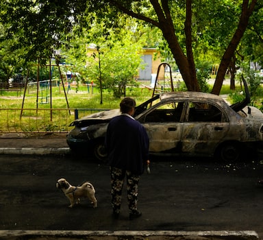 Local residents look at a car burned by a bombing earlier in the day in Mykolaiv, Ukraine, Monday, May 16, 2022. (AP Photo/Francisco Seco)