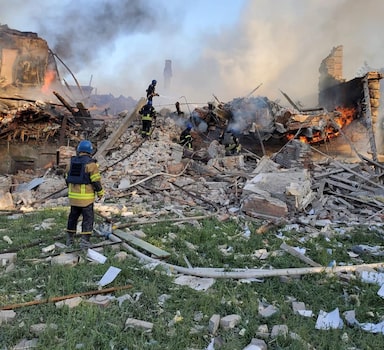 Emergency crew tend to a fire near a burning debris, after a school building was hit as a result of shelling, in the village of Bilohorivka, Luhansk, Ukraine, May 8, 2022. State Emergency Services/Handout via REUTERS ATTENTION EDITORS - THIS IMAGE HAS BEEN PROVIDED BY A THIRD PARTY. NO RESALES. NO ARCHIVES?