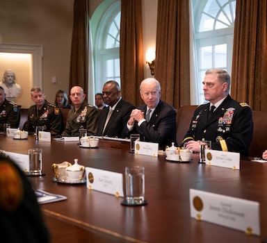 President Joe Biden is flanked by Defense Secretary Lloyd Austin, left, and Gen. Mark Milley, chairman of the Joint Chiefs of Staff, as he meets with military commanders at the White House on Wednesday, April 20, 2022. Reflecting a renewed sense of urgency, Biden announced that the United States would send the Ukrainians $800 million more in military aid.  (Sarahbeth Maney/The New York Times)