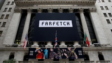 FILE PHOTO: A banner to celebrate the IPO of online fashion house Farfetch is displayed on the facade of the of the New York Stock Exchange (NYSE) in New York, U.S., September 21, 2018. REUTERS/Brendan McDermid/File Photo