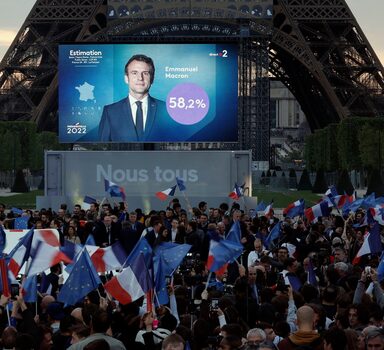 Supporters of French President Emmanuel Macron,  candidate for his re-election,  react after results were announced in the second round vote of the 2022 French presidential election, near Eiffel Tower, at the Champs de Mars in Paris, France April 24, 2022. REUTERS/Benoit Tessier
