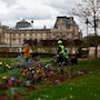 People walk with their bicycles in the Tuileries Gardens near the Louvre museum in Paris, France, March 27, 2024. REUTERS/Gonzalo Fuentes
