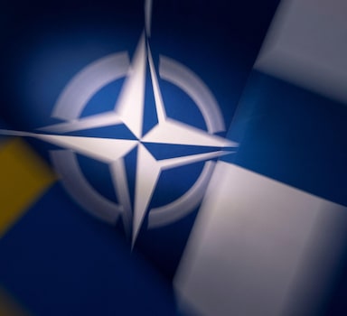 NATO, Swedish and Finnish flags are seen in this illustration taken May 12, 2022. REUTERS/Dado Ruvic/Illustration