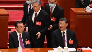 CORRECTION / China's President Xi Jinping (R) sits beside Premier Li Keqiang (L) as former president Hu Jintao is assisted to leave from the closing ceremony of the 20th Chinese Communist Party's Congress at the Great Hall of the People in Beijing on October 22, 2022. (Photo by Noel CELIS / AFP) / “The erroneous mention[s] appearing in the metadata of this photo by Noel CELIS has been modified in AFP systems in the following manner: [clarifying caption to state China's former president Hu Jintao is assisted to leave from the closing ceremony] instead of [being assisted to his seat]. Please immediately remove the erroneous mention[s] from all your online services and delete it (them) from your servers. If you have been authorized by AFP to distribute it (them) to third parties, please ensure that the same actions are carried out by them. Failure to promptly comply with these instructions will entail liability on your part for any continued or post notification usage. Therefore we thank you very much for all your attention and prompt action. We are sorry for the inconvenience this notification may cause and remain at your disposal for any further information you may require.”. Foto: Noel Celis/AFP
