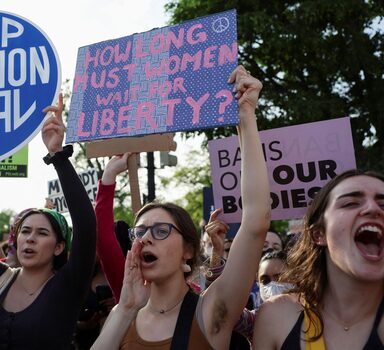Demonstrators hold signs during a protest outside the U.S. Supreme Court, after the leak of a draft majority opinion written by Justice Samuel Alito preparing for a majority of the court to overturn the landmark Roe v. Wade abortion rights decision later this year, in Washington, U.S., May 3, 2022. REUTERS/Evelyn Hockstein