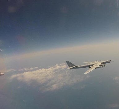 Russian Tu-95 strategic bomber flies during Russian-Chinese military aerial exercises to patrol the Asia-Pacific region, at an unidentified location, in this still image taken from a video released May 24, 2022. Russian Defence Ministry/Handout via REUTERS ATTENTION EDITORS - THIS IMAGE WAS PROVIDED BY A THIRD PARTY. NO RESALES. NO ARCHIVES. MANDATORY CREDIT.