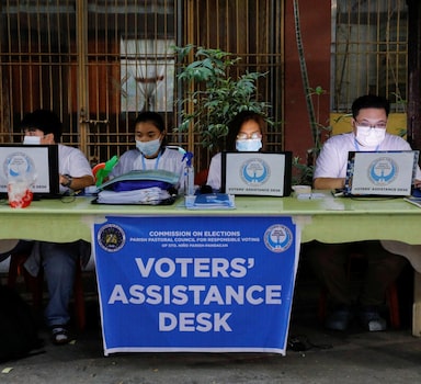 Staff members prepare at a polling precinct during the national elections in Manila, Philippines, May 9, 2022. REUTERS/Willy Kurniawan