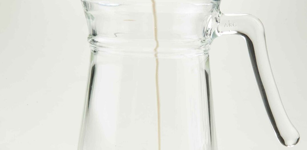 Garrafa de leite colocando leite dentro de copo de vidro. Foto: Daniel Teixeira/Estadão