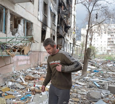 Local resident Viacheslav walks on debris of a residential building damaged by a military strike, as Russia's attack on Ukraine continues, in Sievierodonetsk, Luhansk region, Ukraine April 16, 2022.  REUTERS/Serhii Nuzhnenko