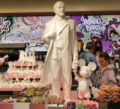 People buy souvenirs in a souvenir shop in St. Petersburg, Russia, Monday, May 23, 2022, with a sculpture of Soviet Union founder Vladimir Lenin and Mickey Mouse in the centre. (AP Photo)
