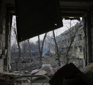 FILE - Debris covers the yard of a maternity hospital damaged in a shelling attack in Mariupol, Ukraine, Wednesday, March 9, 2022. Accounts by three doctors at a Ukrainian maternity hospita hit by an airstrike and an analysis of the crater disprove Russian misinformation about the March 9 attack that killed a pregnant woman and her unborn child. (AP Photo/Evgeniy Maloletka, File)