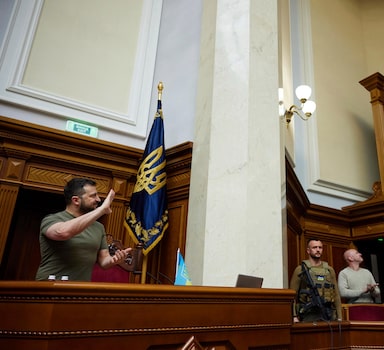 In this image released by the Ukrainian Presidential Press Office, Ukrainian President Volodymyr Zelenskyy, left, waves to a screen showing Britain's Prime Minister Boris Johnson via videolink, during a session at Ukraine's parliament, in Kyiv, Ukraine, Tuesday, May 3, 2022. (Ukrainian Presidential Press Office via AP)