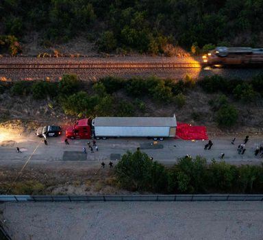 TOPSHOT - SAN ANTONIO, TX - JUNE 27: In this aerial view, members of law enforcement investigate a tractor trailer on June 27, 2022 in San Antonio, Texas. According to reports, at least 46 people, who are believed migrant workers from Mexico, were found dead in an abandoned tractor trailer. Over a dozen victims were found alive, suffering from heat stroke and taken to local hospitals.   Jordan Vonderhaar/Getty Images/AFP (Photo by Jordan Vonderhaar / GETTY IMAGES NORTH AMERICA / Getty Images via AFP)