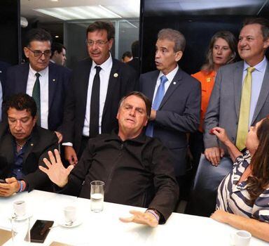 This handout picture released by the Brazilian Liberal Party shows former Brazilian President Jair Bolsonaro (C) gesturing during a meeting with the party's lawmakers at the Liberal Party headquarters in Brasilia on March 30, 2023. - Three months after leaving for the United States in the final hours of his term, Brazil's ex-president Jair Bolsonaro returned home Thursday to reenter politics -- complicating life for his successor and nemesis, Luiz Inacio Lula da Silva. The far-right ex-army captain, who skipped town two days before Lula's inauguration on January 1, arrived back in Brasilia on a commercial flight from Orlando, Florida. (Photo by Handout / Liberal Party / AFP) / RESTRICTED TO EDITORIAL USE - MANDATORY CREDIT "AFP PHOTO / BRAZILIAN LIBERAL PARTY" - NO MARKETING NO ADVERTISING CAMPAIGNS - DISTRIBUTED AS A SERVICE TO CLIENTS