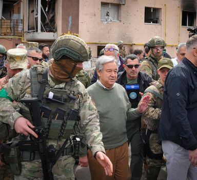 U.N. Secretary-General Antonio Guterres, center, looks at the houses destroyed by Russian shelling in Irpin, on the outskirts of Kyiv, Ukraine, Thursday, April 28, 2022. (AP Photo/Efrem Lukatsky)